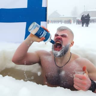 drinking from a bottle of beer in the snow